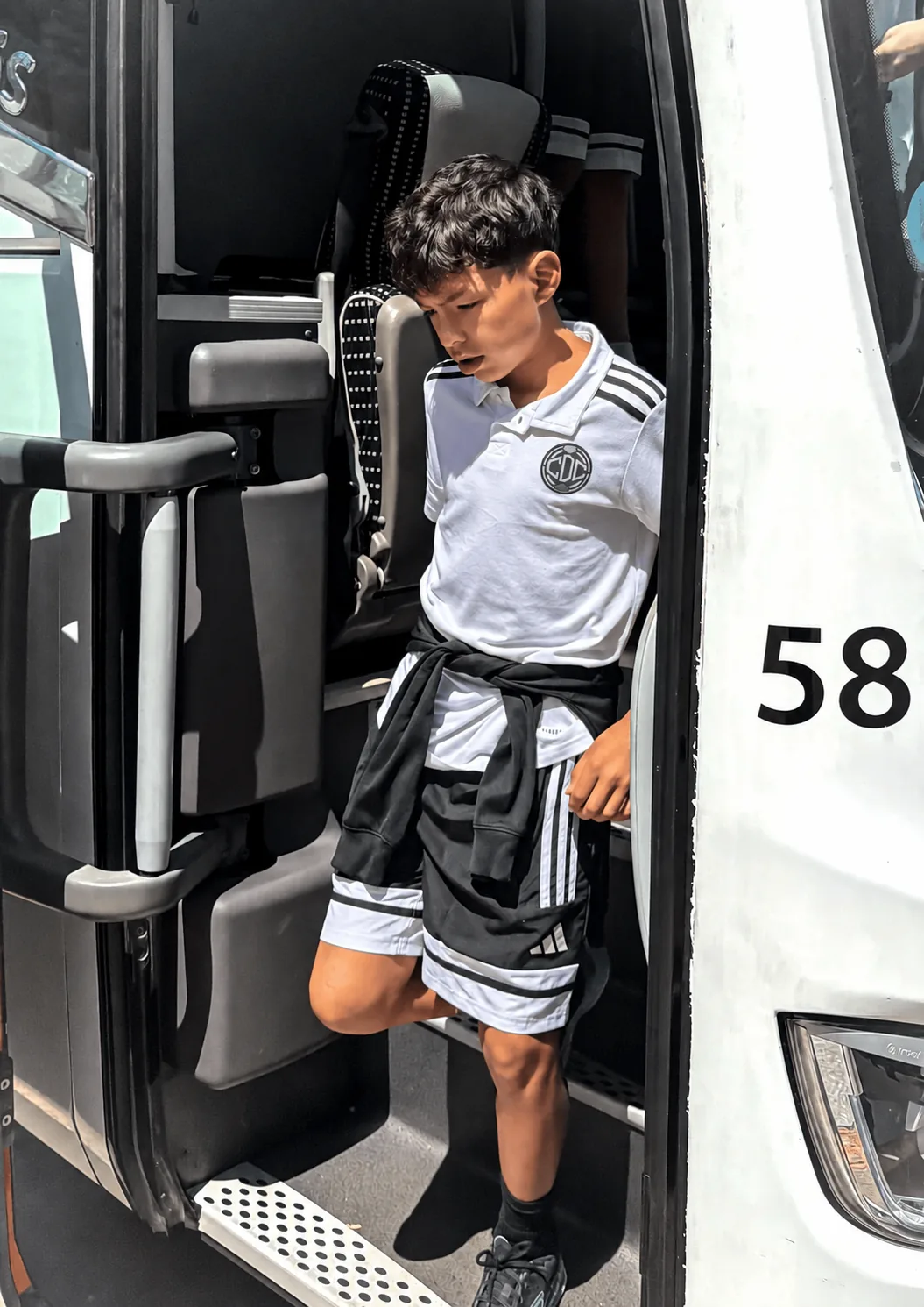 A player stepping off the team bus on the way to a match